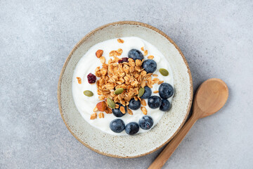 Greek yogurt bowl with blueberries, granola topping. Healthy food meal, rich in protein and dietary fiber