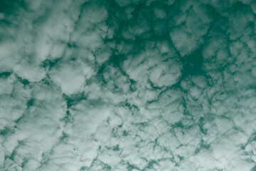 Nature background of sky with blue clouds on sunset. Beautiful cloud above dramatic blue sunset sky.