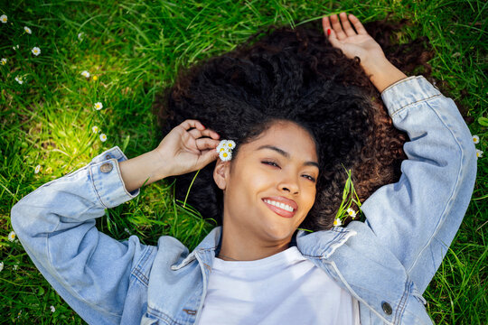Woman enjoying leisure time lying on grass