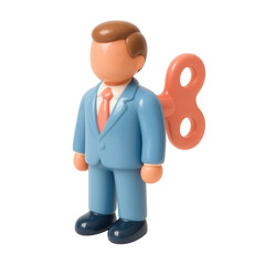 Vintage toy wind-up businessman in blue suit with orange wind-up key