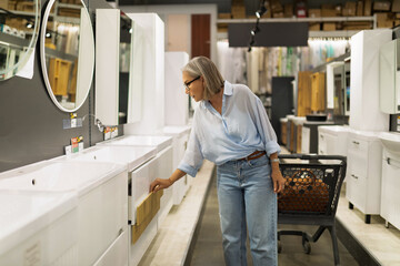 Exploring home improvement: Woman engages in shopping at a retail store for kitchen and decor items