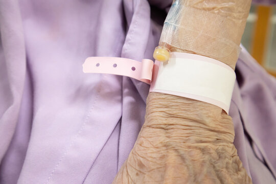 Close-Up of Elderly Patient's Wrist with ID Band in Hospital Setting