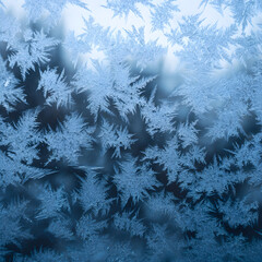Ice crystals forming beautiful pattern on frozen window in winter
