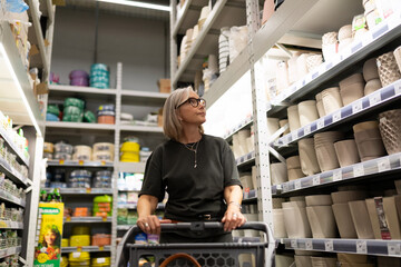 Woman experiences shopping moments in a modern retail environment, exploring home goods and decor...