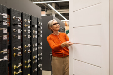 Middle-aged woman exploring a home improvement store in various departments for her shopping needs