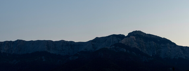 panorama mountain range under clear blue summer sky.