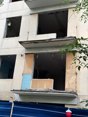 Abandoned Apartment Building with Broken Windows and Exposed Interior