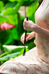 a Chinese woman holding a fan