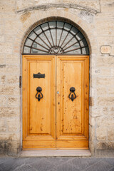 Elegant wooden door enhancing a stone wall in tuscany