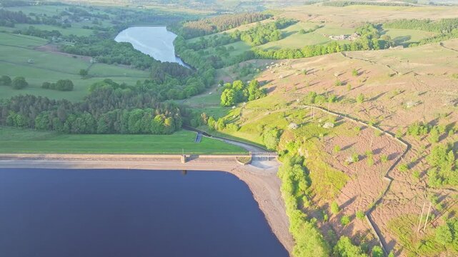 Establishing drone shot of Strines Reservoir, water storage reservoir, with forest during the day near Sheffield, South Yorkshire, England