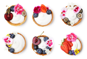 Tartlets decorated with flowers isolated on white, set. Top view. Tasty dessert