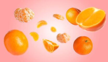 Juicy tangerines swirling in air against pink gradient background
