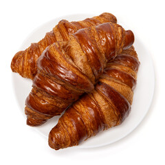 Three freshly baked classic delicious fresh organic croissants on white ceramic plate isolated on white background