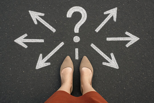 Generative AI: woman in shoes standing on asphalt next to multitude of arrows in different directions and question mark, confusion choice chaos concept
