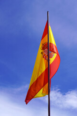 Flag of Spain with Blue Sky Background