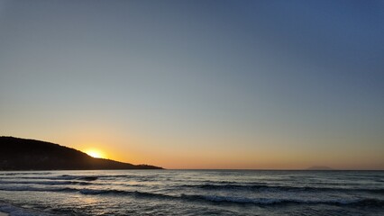a a movement of stars in the night sky with the view of mountains.