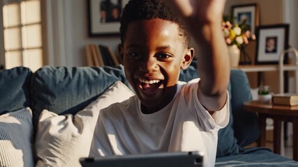 Boy is smiling while holding tablet. Boy sitting on tablet in living room. A woman relaxes in a casual environment focused on technology. A boy is grinning as he holds a tablet lifestyle.