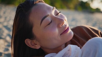 A woman laying on the beach. Woman relaxing on the beach at sunset. A summer vacation in nature with nature. A woman reclining on the shore lifestyle. - Powered by Adobe