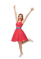 Naklejka premium Joyful woman wearing a vintage-style red polka dot dress with raised arms celebrating on white background.