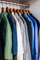 Color coordinated shirts hanging in closet