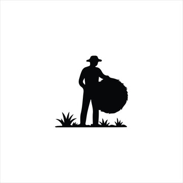 Silhouette of a farmer in a hat holding a hay bale in a field straw agriculture