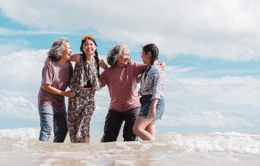 Happy Asian family across generations enjoying the beach. Seniors and children joyful smiles, wellness, love, and the importance of family connection.