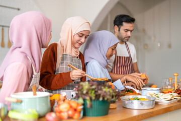 Muslim family cooking together in kitchen preparing food with fresh vegetables, islamic holiday gathering with fresh ingredients and family love, halal food preparation for ramadan or eid celebration