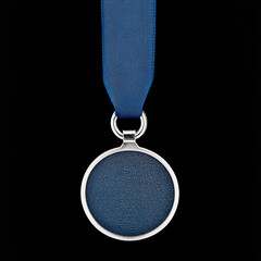 Blank blue medal with a blue ribbon against a black background. Concept of award, achievement, winner, prize.