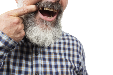 Close-up of senior man pointing at missing tooth, highlighting dental health issues