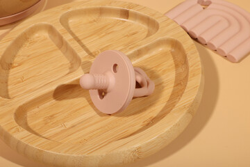 Baby Silicone Pacifier and Bamboo Divided Plate: Minimalist Nursery Decor