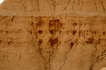 A rock wall with holes in it