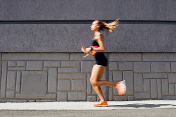 Woman jogging outdoors, motion concept