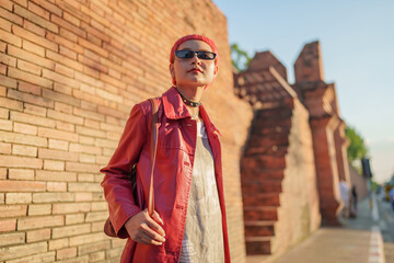 Gen z girl leather fashion with punk Asian woman tourist of local city Southeast Asia travel trendy...
