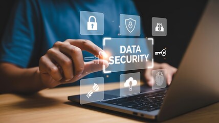 Businessman working on a laptop computer and interacting with a virtual screen interface to manage data security. Cybersecurity concept with lock, shield, and cloud protection icons.