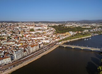 Obraz premium Aerial view of Mondego River and old town of Coimbra, Portugal. On the banks of the river Mondego, Coimbra is famous for its University, the oldest in Portugal and one of the oldest in Europe.