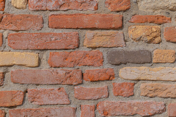 Textured wall revealing the beauty of handcrafted bricks in warm colors