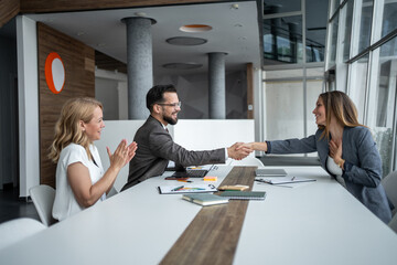 Business people shaking hands congratulating successful partnership agreement
