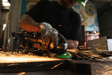 Man cutting metal with grinder