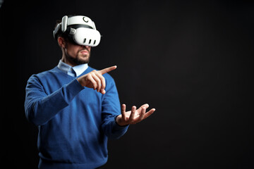 Virtual reality exploration in a dark space with a man wearing a headset and engaging with a virtual environment in real time