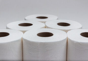 Toilet paper rolls in pyramid shape with gray background. Version 1.