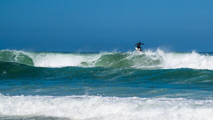 Surfer riding a wave on Contis beach, Saint Julien en Born , Saint-Julien-en-Born, Landes, France, Europe