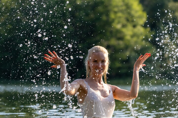 Woman in White Dress Playing with Water Splash Outdoors
