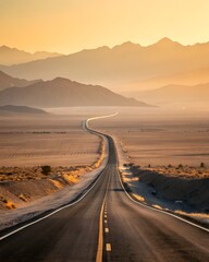 Fototapeta premium A long, winding road stretches through a desert landscape. Mountains rise in the background under a warm sunset sky. The scene conveys a sense of adventure and exploration.