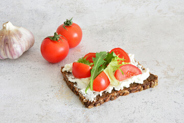 A Healthy toast with whole grain bread, tomato and cream cheese