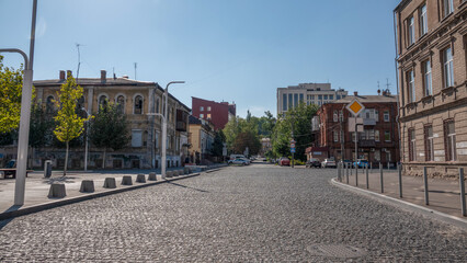 Obraz premium Charming Urban Landscape with Historic Architecture and Cobblestone Street
