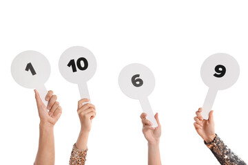 Panel of judges voting with score signs on white background, closeup