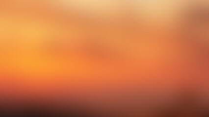 Photo of a warm abstract gradient of orange and yellow with a subtle grainy texture