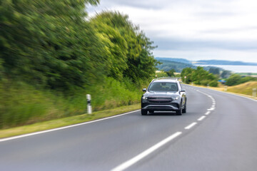 Electric car on road. Vehicle in motion. Dynamic speed blur effect