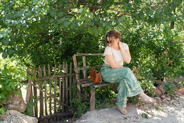 Attractive woman on a small bench by the road portrait outdoor