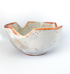 The ceramic cup has been adapted for planting small pot plants